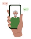 A hand holding a mobile phone with senior African American man on the touch screen. Video call with grandfather or father. Royalty Free Stock Photo